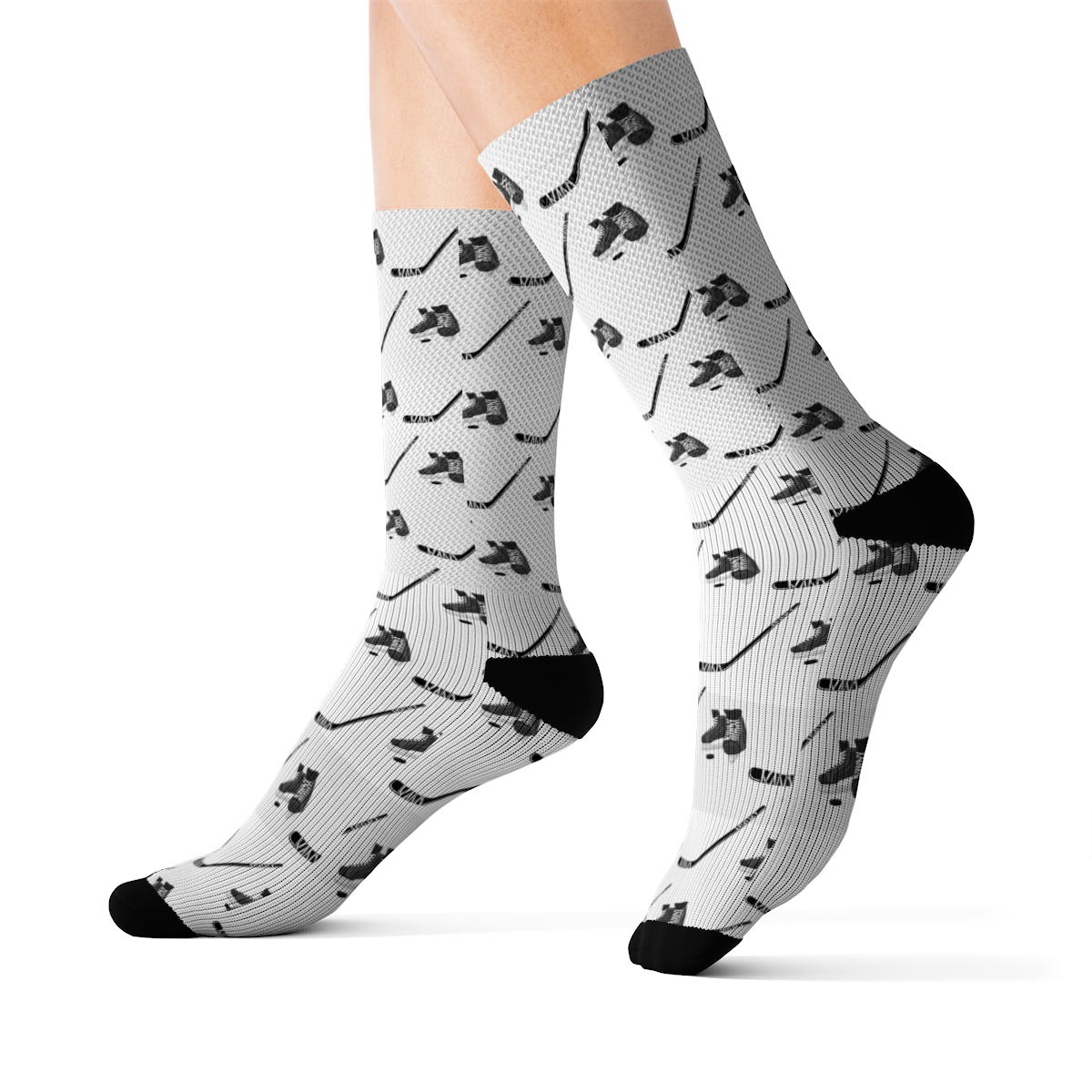 Image of Socks on feet, socks have a hockey print showing skates and sticks