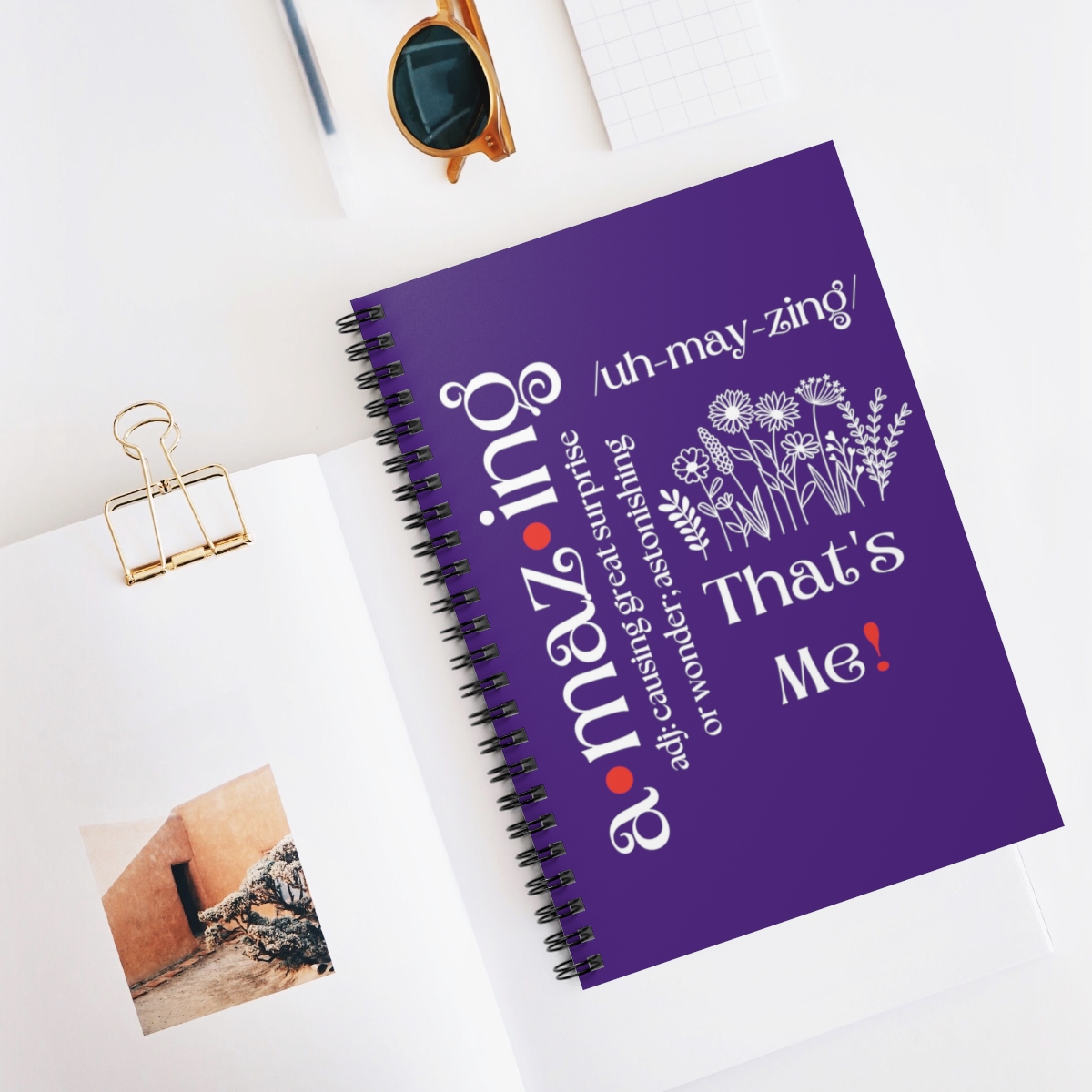 Image of the Amazing Journal in purple displayed on a desk with stationary supplies